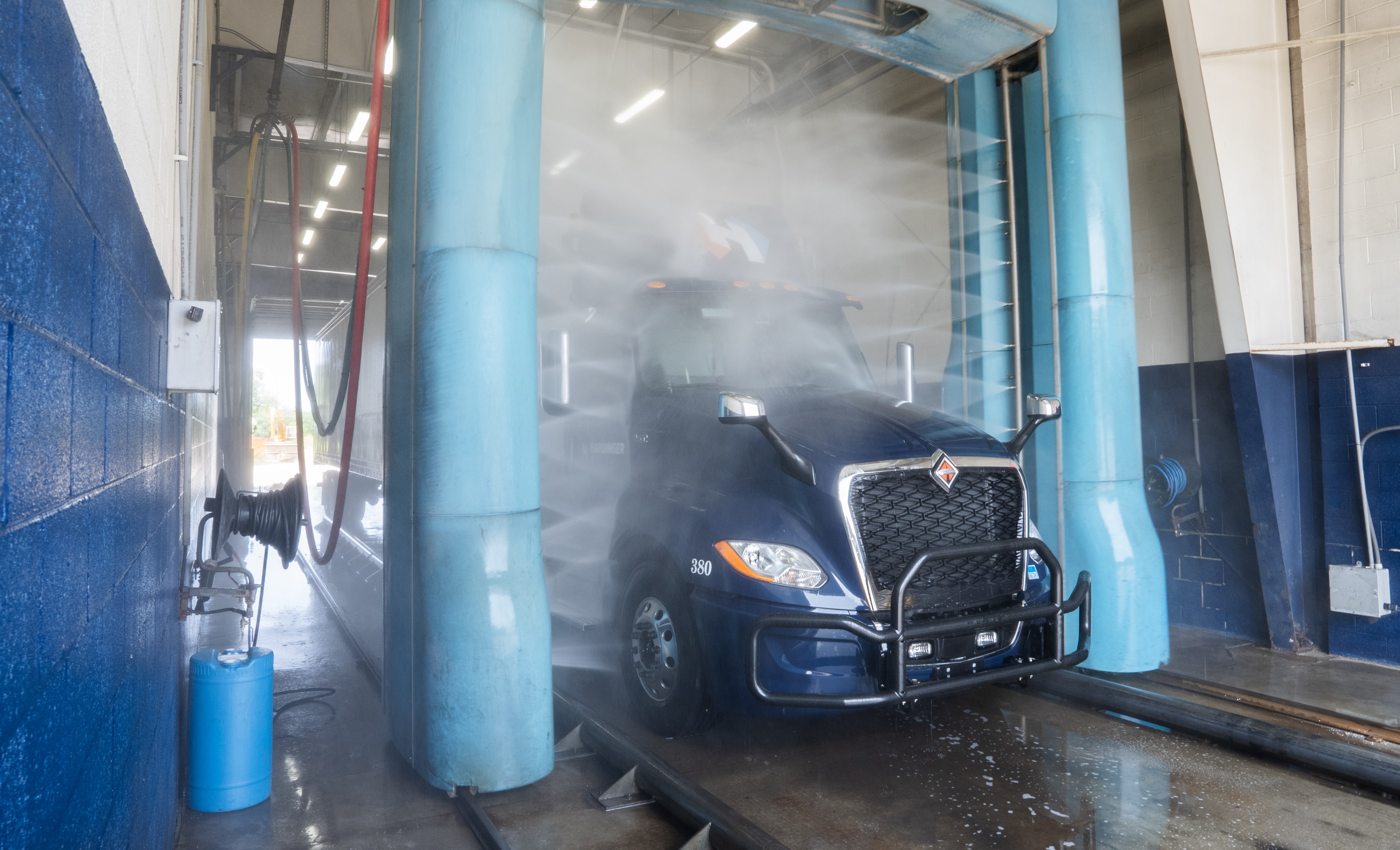 Truck and trailer driving through the EQPT Services truck wash